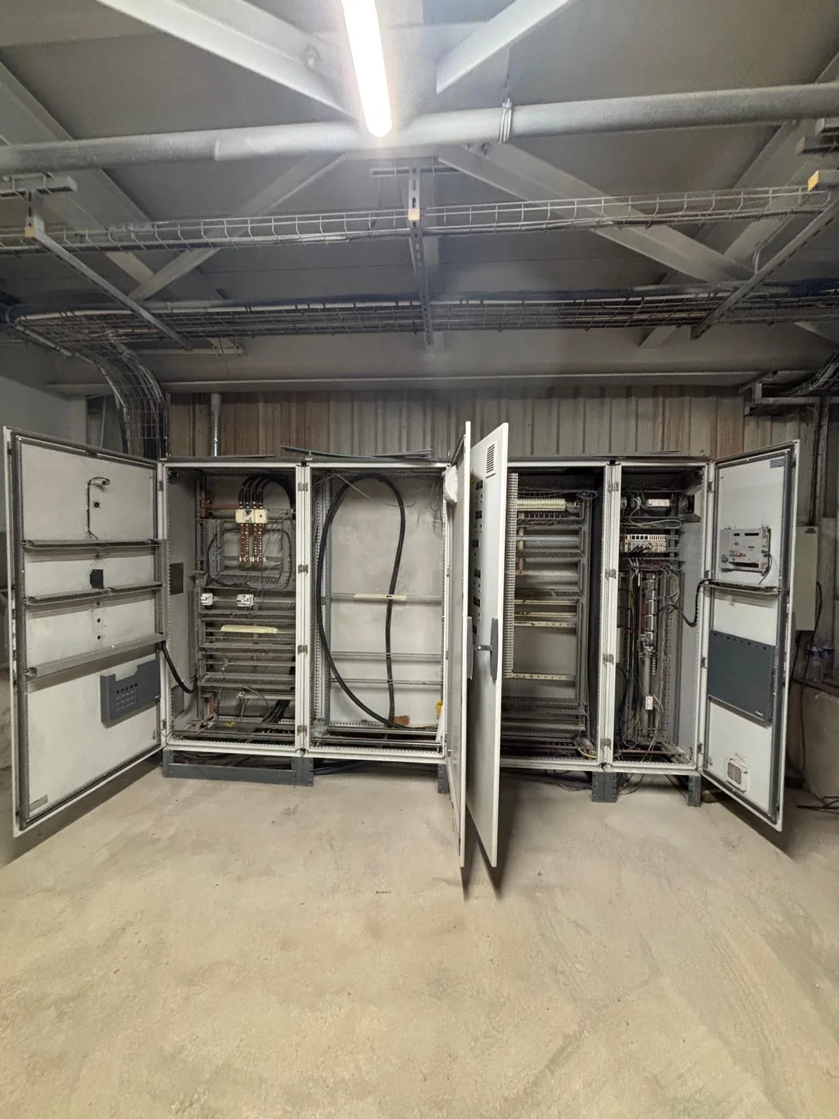 Electrical cabinets and controllers open in a plant room